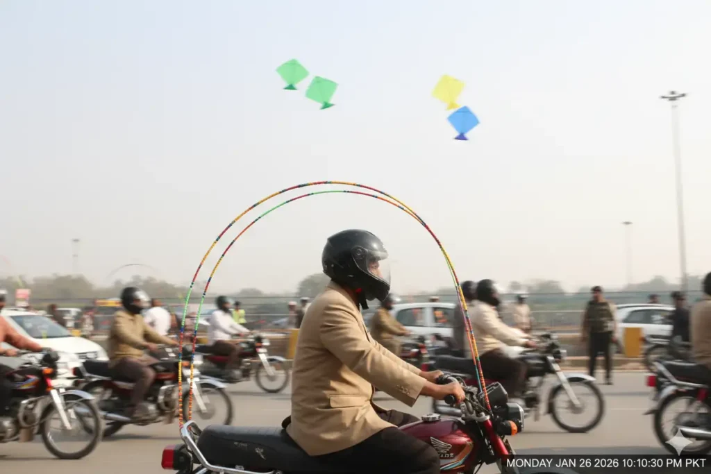 Basant Lahore 2026 Alert. New Traffic Police Rules for Bike Riders 7 Motorcycle rider using U-shaped safety rod while riding during Basant celebrations in Lahore.